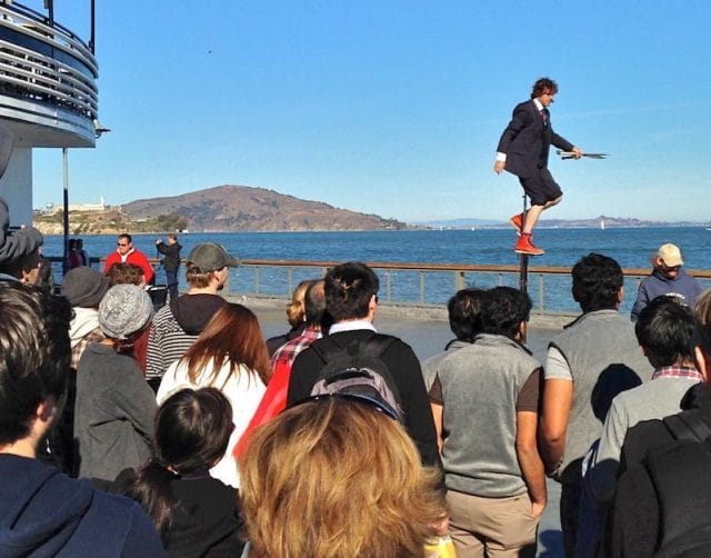 a man jumping in the air with a crowd watching