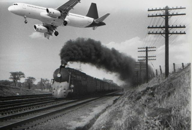 a plane flying over a train