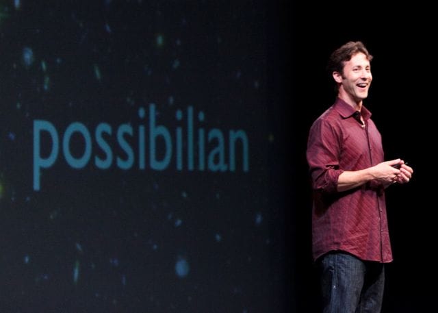 David Eagleman standing in front of a screen with the mouth open