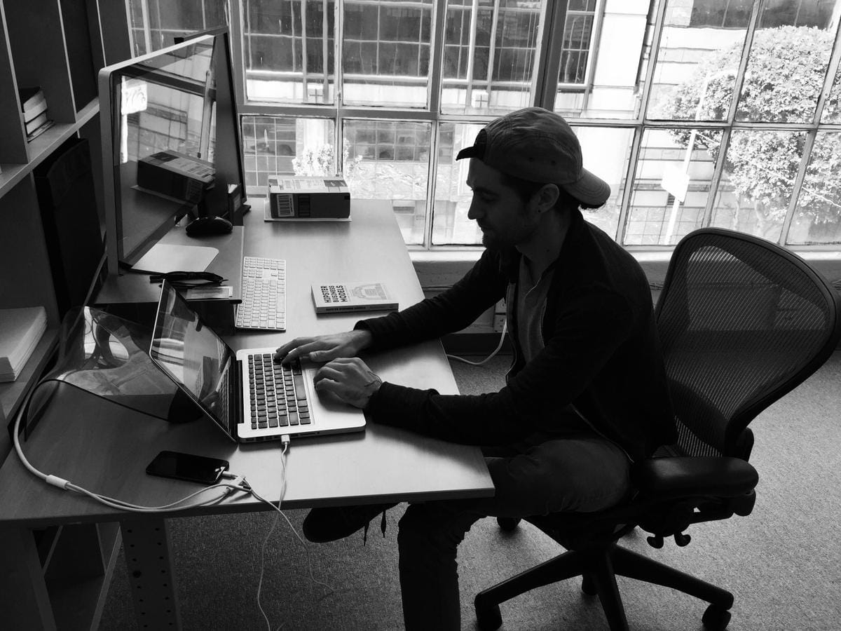 a person sitting at a desk using a computer