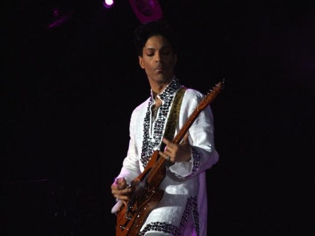 Prince playing a guitar