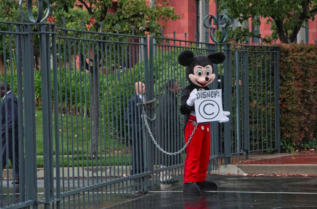 a person in a garment holding a sign