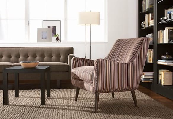 a chair and a table in a room with a bookcase