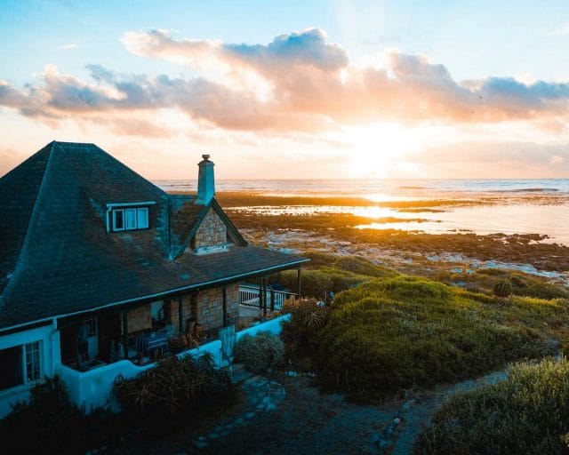 a house on a hill overlooking the ocean