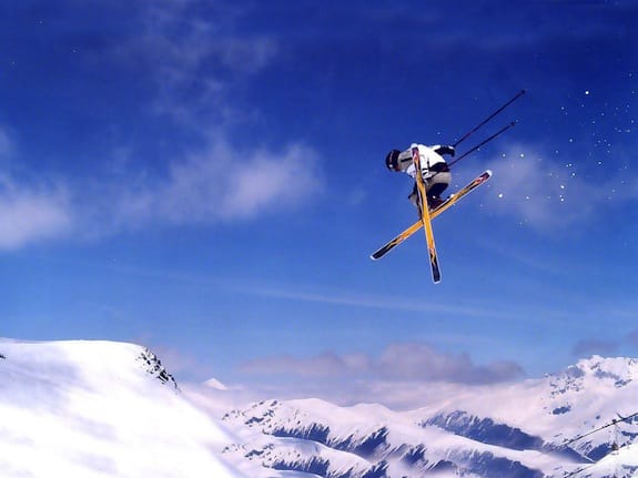a person jumping in the air on skis