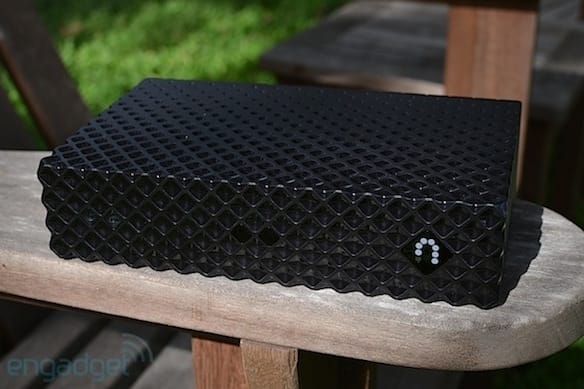 a black and white object on a wooden surface