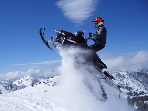 a man riding a snowmobile