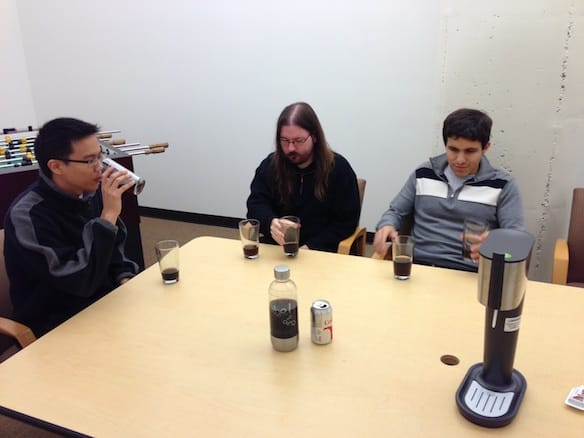 a group of people sitting at a table with drinks and food