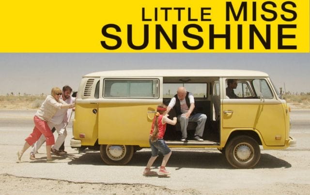 a group of people pushing a van