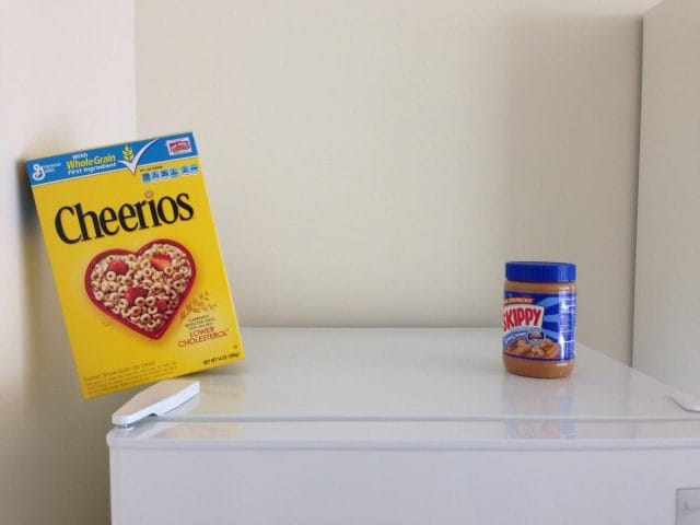 a can of food and a box on a shelf