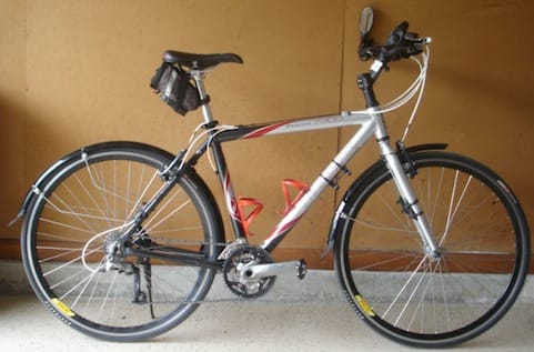 a bicycle parked against a wall