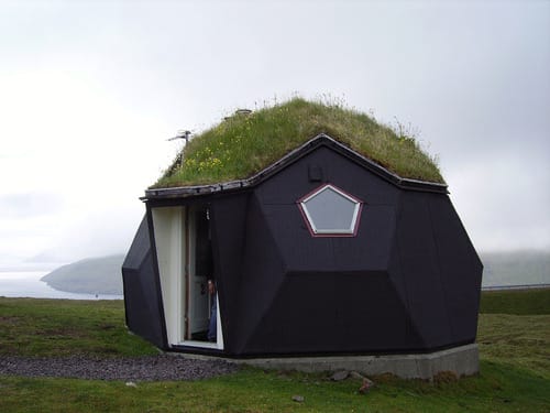 a small house with a grass roof