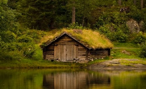a wood shack by a lake