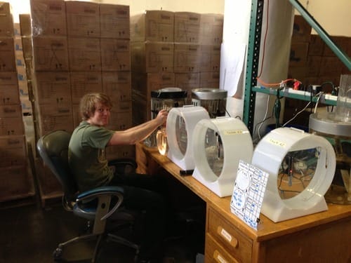 a person sitting at a coffee maker