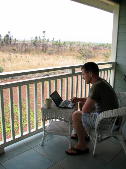 a person sitting on a chair with a laptop on the lap