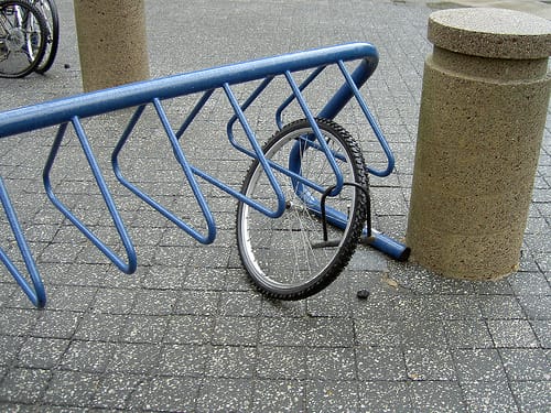 a bicycle leaning against a pole