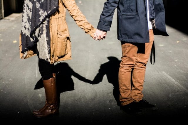 a man and woman holding hands