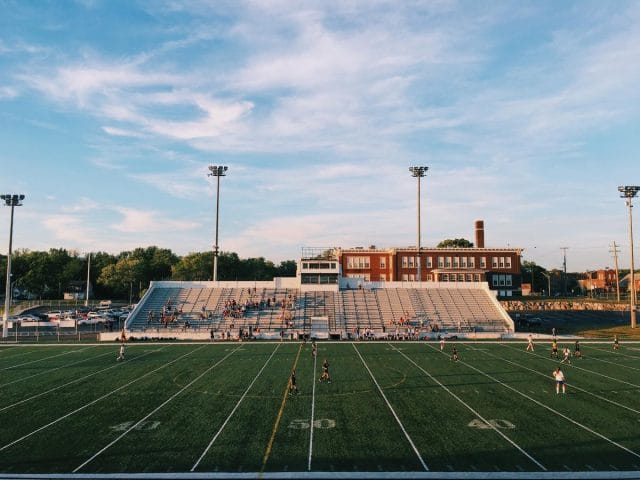 a football field with a crowd watching