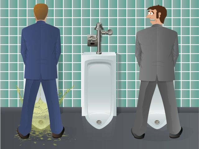a couple of men in suits standing in front of a urinal