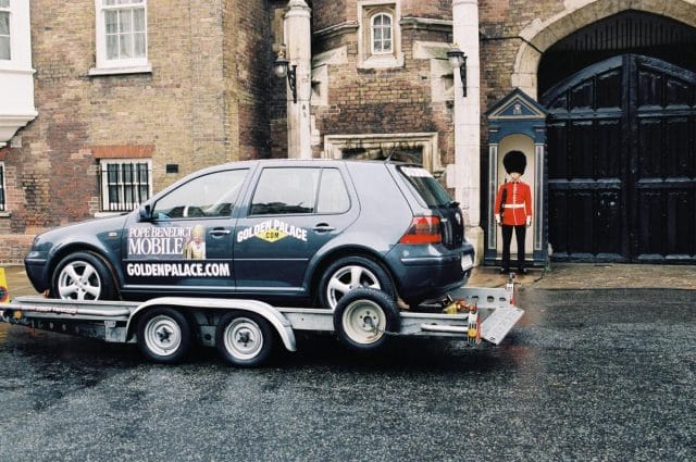 a car with a person standing on the back of it